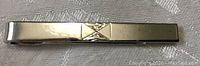 Top view of vintage sterling tie clip showing engraved 'X' detail and overall polished condition