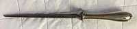 Full view of the letter opener showing the entire length and decorative handle