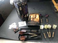 Photo showing three Star Wars VHS tapes, one Lord of the Rings VHS tape, nine assorted darts and carrying case, and extra parts