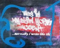 Close-up of graffiti text reading 'This is my New York Accent... normally I write like this' with visible paint texture