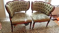Two antique fireside chairs with olive green and gold lame brocade upholstery, one chair shows damage to seat springs.