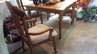Overall view of square dining table and one armchair