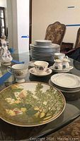 Wide view of Noritake cups, saucers, plates, and other items arranged on table