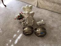 Photo showing two large 16 inch ceramic angel figurines, one smaller angel figurine, ceramic pot with artificial flowers, and two decorative metal wall sconces.