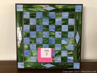 Full front view of the stained glass chess board showing the entire checkered playing surface and decorative glass border.