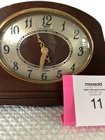 Close-up of the clock face showing the Revere brand name, Westminster Chime label, and Telechron Motored indication with black Arabic numerals.