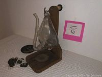 Overall view of the antique glass barometer mounted on wooden plaque with additional mounting hardware and parts lying next to it on cloth surface.