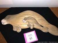 Photo of the full wooden manatee wall plaque showing mother and baby figures carved and painted
