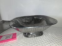 Side angled view of the alligator design metal bowl showing the alligator sculpted shape and skin texture surface.
