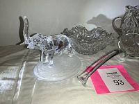 Photo showing clear glass elephant figurine, pressed glass bowl, crystal vase, and large ladle on table