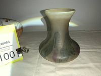 Photo of an art glass vase with matte finish, green and purple colors, rounded body, and flared neck