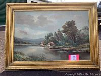 Full view of the framed landscape oil painting showing the entire artwork and frame.