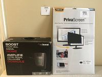 Two product boxes side by side on table against wall