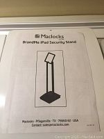Instruction manual for Maclocks BrandMe iPad Security Stand showing product image and contact info.