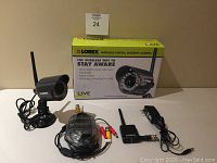 Full view of the camera, wired components, and the original box with product details visible.