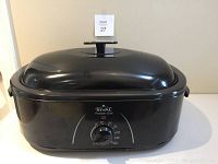 Front view of the Rival Roaster Oven with lid on, showing overall shape and size.