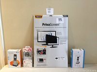 Lot items including new sealed Fellowes PrivaScreen privacy filter 24" widescreen, AT&T handsets TL86003 sealed and TL88002 open box, Motorola H730 wireless headset with charger open box.