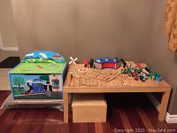 Wide shot of entire train table with removable legs, toy box, storage box