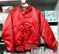 Front view of red satin jacket. Visible striped knit collar and cuffs. Snap buttons down front. Two side pockets.