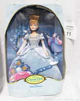 Front view of vintage boxed Cinderella doll from Walt Disney Classic Doll Collection, showing doll in light blue dress and original packaging with some wear.