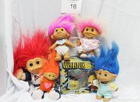 Photo showing six vintage troll dolls in various hair colors and styles arranged together, including the Ideal Toy Corp Wishnik box as part of the lot.