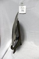 Side view showing the curved pewter plate standing on the heavy brass stand