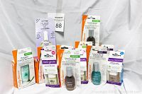 Photo showing 12 brand new nail care products from Sally Hansen and Dr. Marvey arranged on a plain white backdrop including cuticle removers, base coats, strengtheners, and nail growth treatments in various packaging.