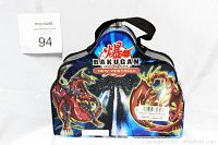 Packaged Bakugan Battle Brawlers tin case featuring New Vestroia artwork with characters on the front.