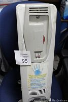 Front view of Delonghi portable electric radiator heater showing control switches, vents, and brand label.