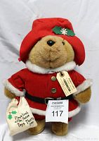 Photo of vintage Paddington Bear in red Santa outfit showing original tag and small fabric bag with message