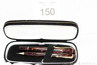 Pen and pencil set in black and white velvet lined box, showing item arrangement and condition.