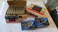 Box of 20 Sony HF 90 cassette tapes and two boxes of sealed Memorex C60 cassette tapes shown together.