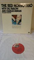 Front cover of The Red Norvo Trio with Tal Farlow and Charles Mingus double vinyl album The Savoy Sessions showing photo and text on white background.