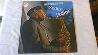 Front cover of 'Great Moments with Sonny Rollins' double vinyl album showing Sonny Rollins playing saxophone, MCA Impulse label.