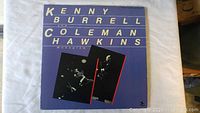 Front cover of the Kenny Burrell and Coleman Hawkins album, showing title text and performance photos on a purple background.