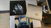 Overview photo showing three vinyl record album covers: Genesis 'Seconds Out', Genesis 'Wind & Wuthering', and a Peter Gabriel album with an abstract face close-up cover.