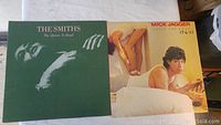 Two vinyl album covers side by side: The Smiths' "The Queen Is Dead" and Mick Jagger's "She's the Boss" in good condition.