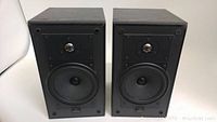 Front view of both Celestion 5 bookshelf speakers showing two drivers on each, black finish, no grills.