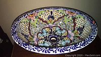 Top view of the oval hand-painted porcelain sink showing floral and detailed colorful designs.