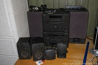 Full view of Onkyo stereo stack with two large speakers and four smaller supplemental speakers plus the RadioShack speaker control center on top.