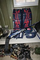 Vaughn goalie leg pads, glove, blocker and Bauer stick on table showing overall item condition