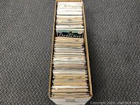 Cardboard longbox filled with bagged comic books, front view