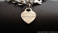 Close-up of heart charm showing “Please Return to Tiffany & Co. New York” inscription