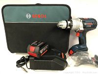 Overview of drill, two batteries, charger and carrying case