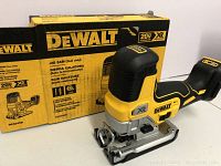 DeWalt box and cordless jigsaw with battery mount attached