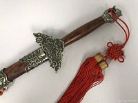 Full view of sheathed sword showing scabbard, fittings, and tassel