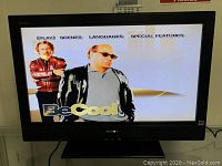 Front view of Sony TV showing screen displaying digital menu interface with 'Be Cool' movie menu.