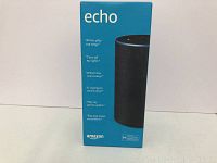 Front of Amazon Echo box showing image of speaker and key Alexa voice command examples.