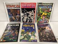 Six Teenage Mutant Ninja Turtles comic books displayed in two rows, showing colorful illustrated covers with turtles, humans, and creatures.