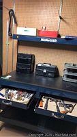 Workbench area with Mastercraft tools, tool drawers open displaying various hand tools, and tackle boxes on shelf